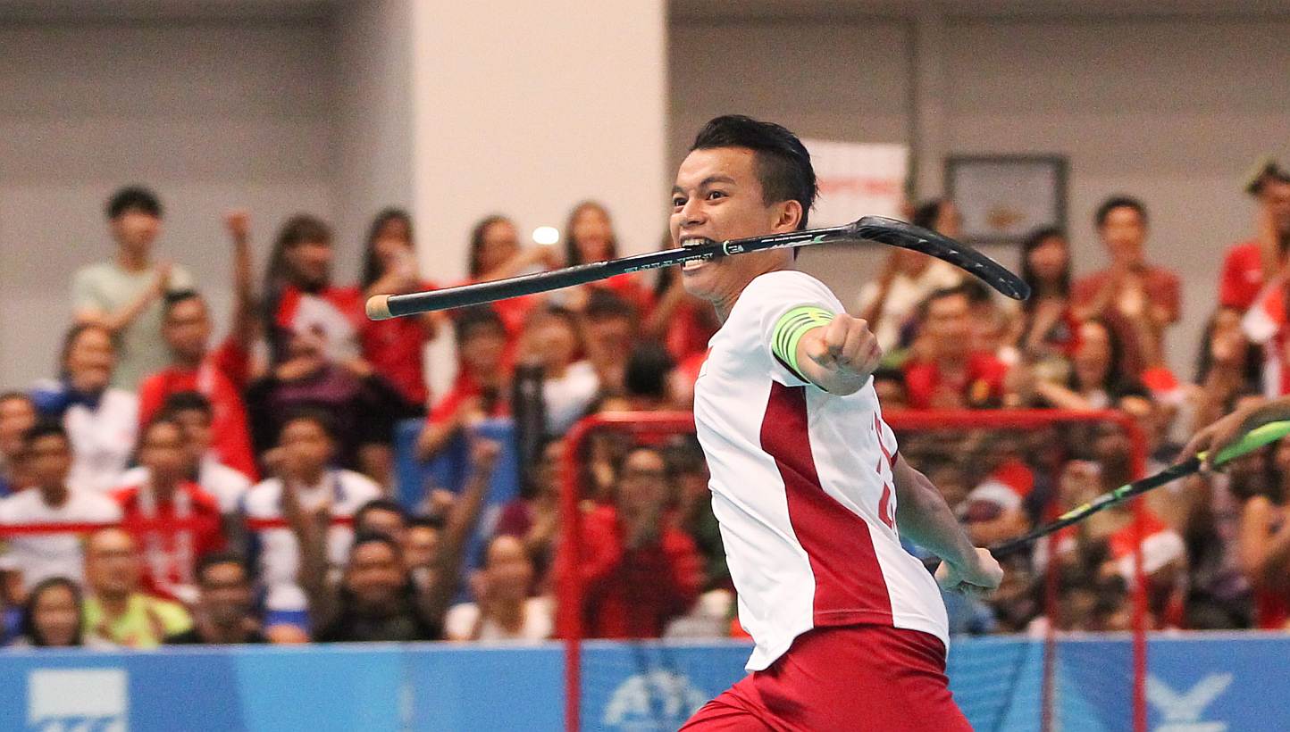 Singapore floorball men's team captain Syazni Ramlee celebrating after scoring a goal against Thailand in the SEA Games men's floorball final. Singapore beat Thailand 9-0 to win the gold. -- ST PHOTO: ONG WEE JIN