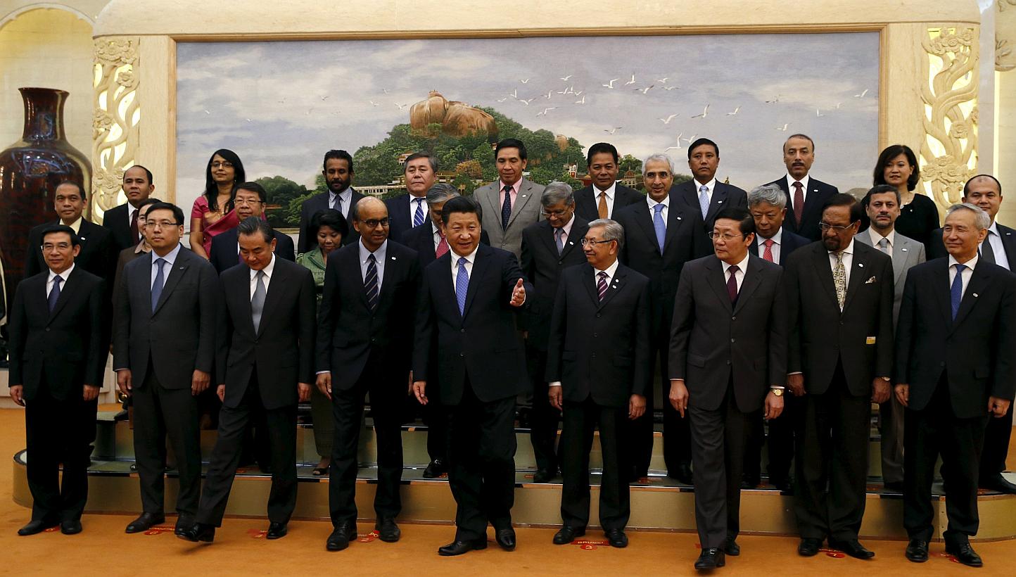 China's President Xi Jinping (front, centre) guiding guests at the Asian Infrastructure Investment Bank launch ceremony at the Great Hall of the People in Beijing on Oct 24, 2014. -- PHOTO: REUTERS&nbsp;