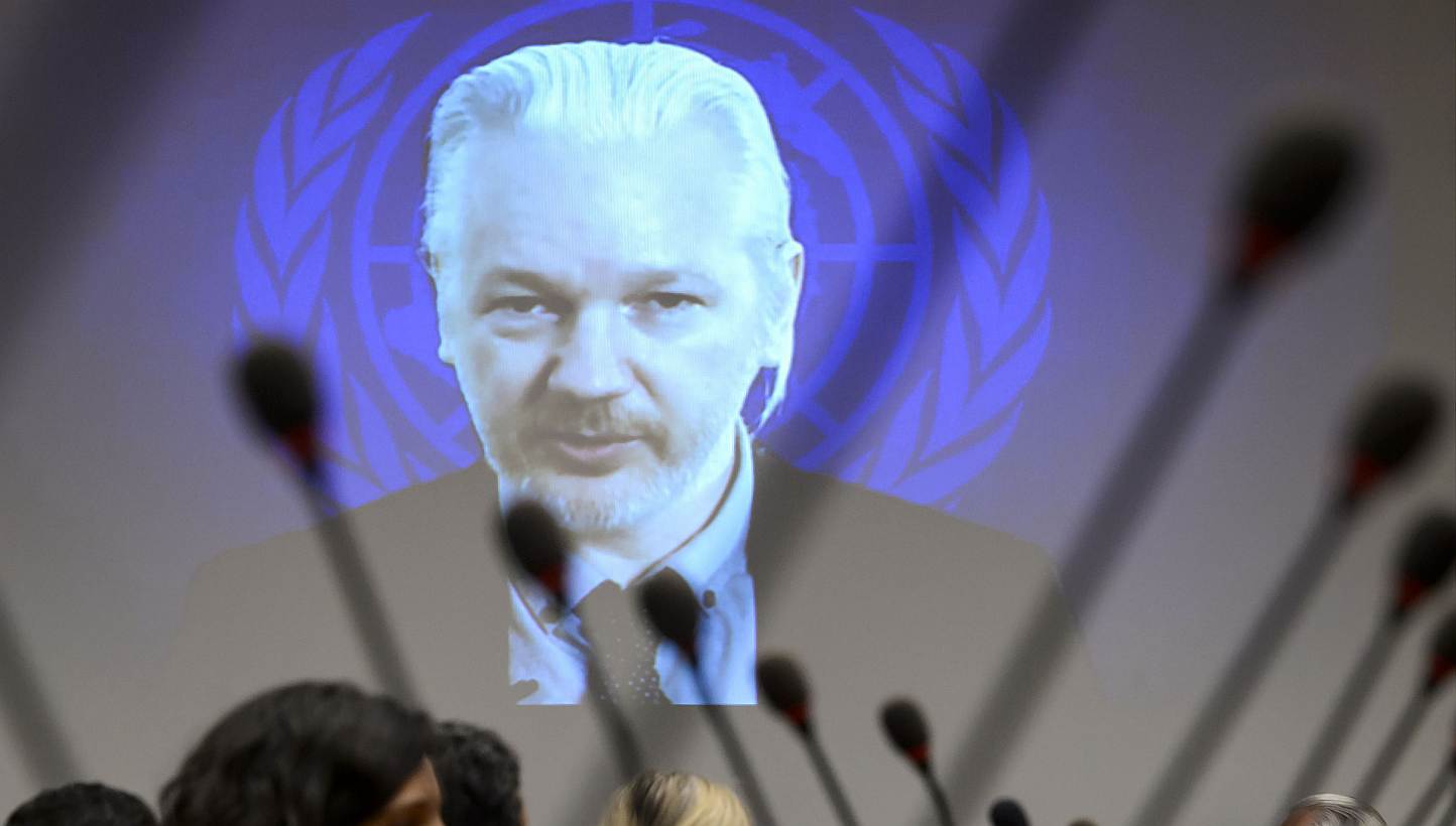 WikiLeaks founder Julian Assange is seen on a screen speaking via web cast from the Ecuadorian Embassy in London during an event on the sideline of the United Nations (UN) Human Rights Council session on March 23, 2015 in Geneva. Swedish prosecu