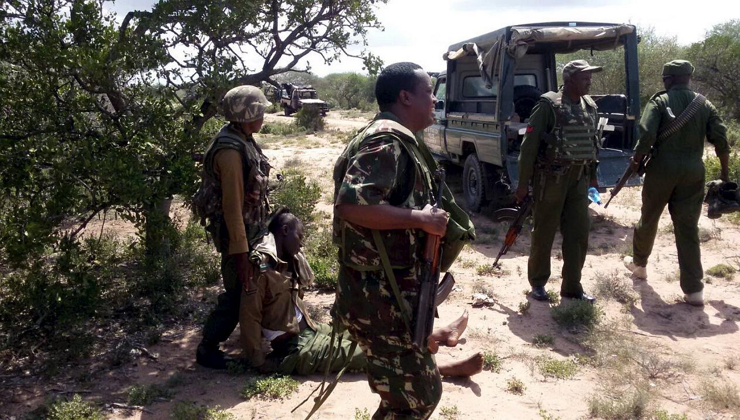 An injured administration police officer is helped by his colleagues after they were ambushed by Somalia's Al-Shebab fighters in Yumbis village near the Kenya-Somalia border on May 26, 2015.&nbsp;A British militant fighting for Somalia's Al-Qaeda aff