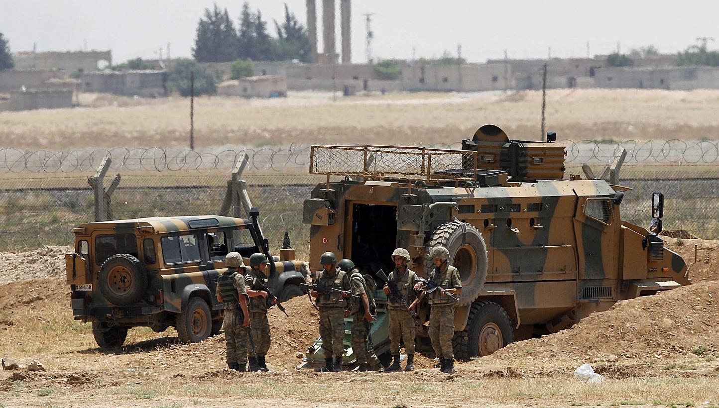 A picture taken from the Turkish side of the border between Turkey and Syria shows Turkish soldiers guarding at the Syrian-Turkish border line in Akcakale, Sanliurfa province, south-eastern Turkey on June 15, 2015. Syrian Kurdish forces on Monday cut