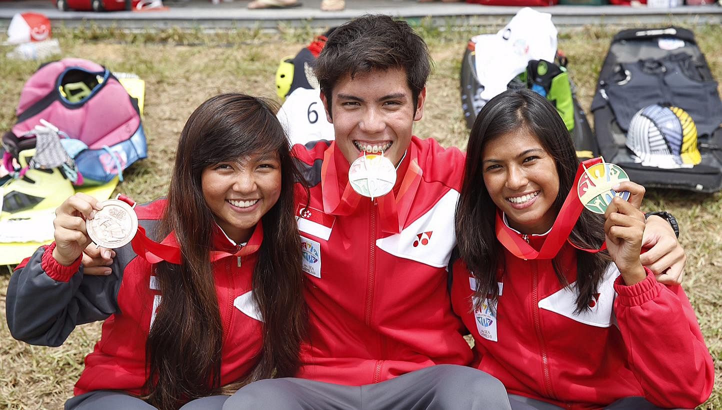 Singapore's Sasha Christian (right) and Mark Leong with their gold medals from the SEA Games waterski women's and men's slalom finals respectively, and Kalya Kee (left) with her bronze medal from women's slalom final&nbsp;at Bedok Reservoir on June 1