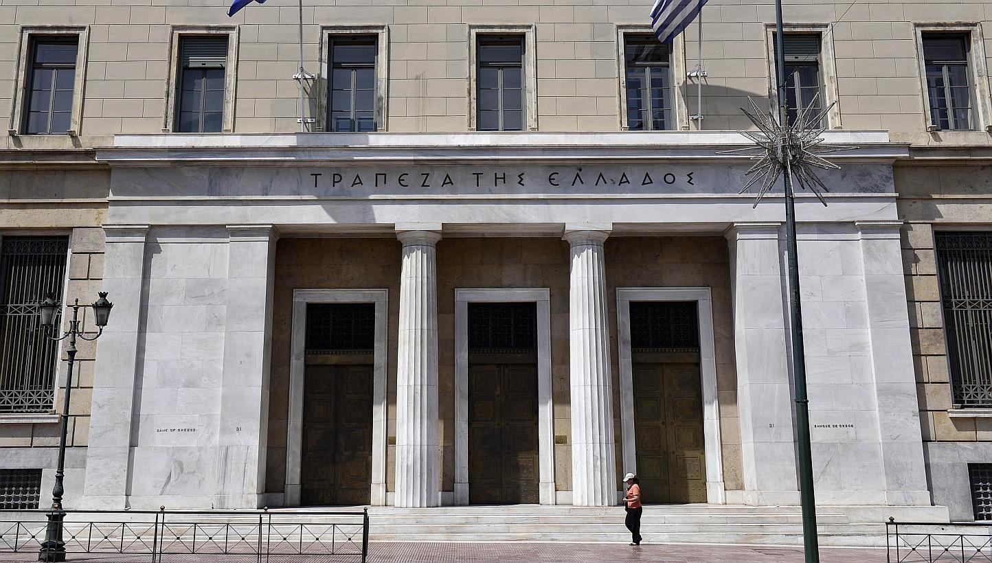 A woman walking past Bank of Greece headquarters in central Athens on June 15, 2015. US stocks retreated, with the Standard &amp; Poor's 500 Index slipping below its average price during the past 100 days, after weekend negotiations between Greece an