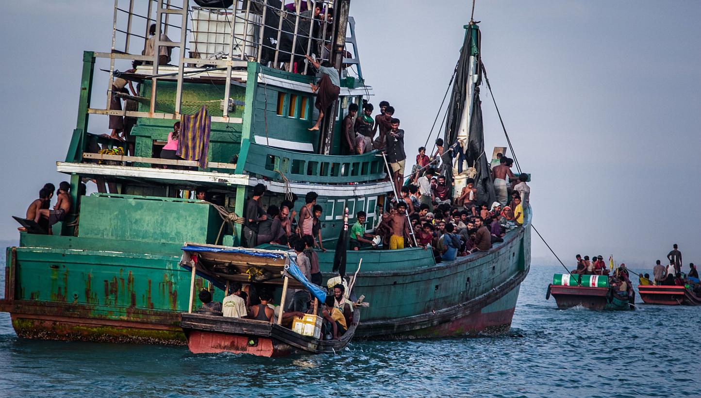 This photograph taken on May 20, 2015 shows Rohingya migrants resting on a boat off the coast near Kuala Simpang Tiga in Indonesia's East Aceh district of Aceh province before being rescued. Australian authorities work within the law to stop asylum s