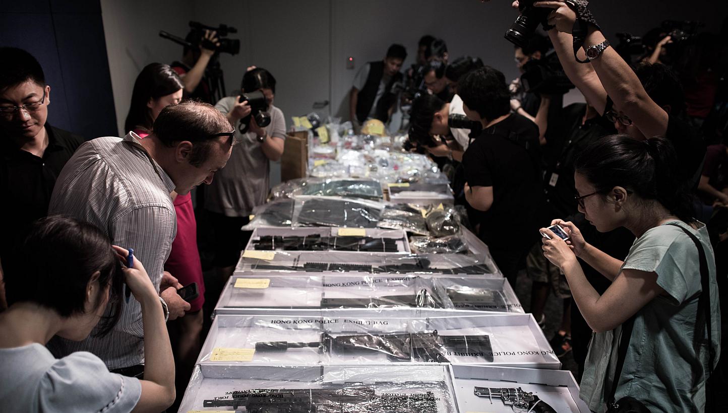 Air rifles and other seized items are displayed before a press conference at the police headquarters in Hong Kong on June 15, 2015, after suspected explosives were seized at an abandoned television studio in the east coast district of Sai Kung. -- PH