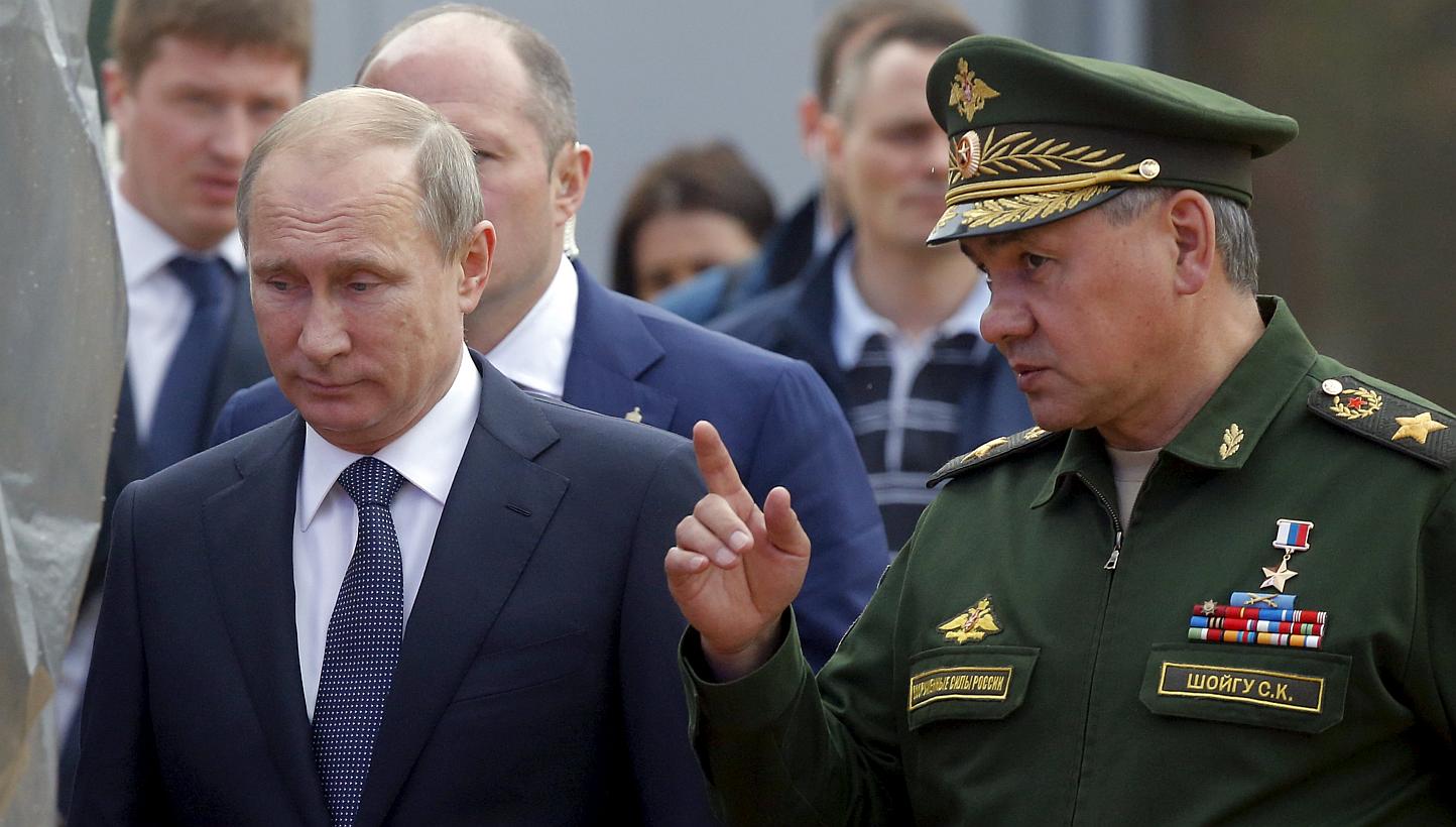 Russian President Vladimir Putin (left) listens to Defence Minister Sergei Shoigu as they arrive for the opening of the Army-2015 international military forum in Kubinka, outside Moscow, Russia, June 16, 2015. -- PHOTO: REUTERS