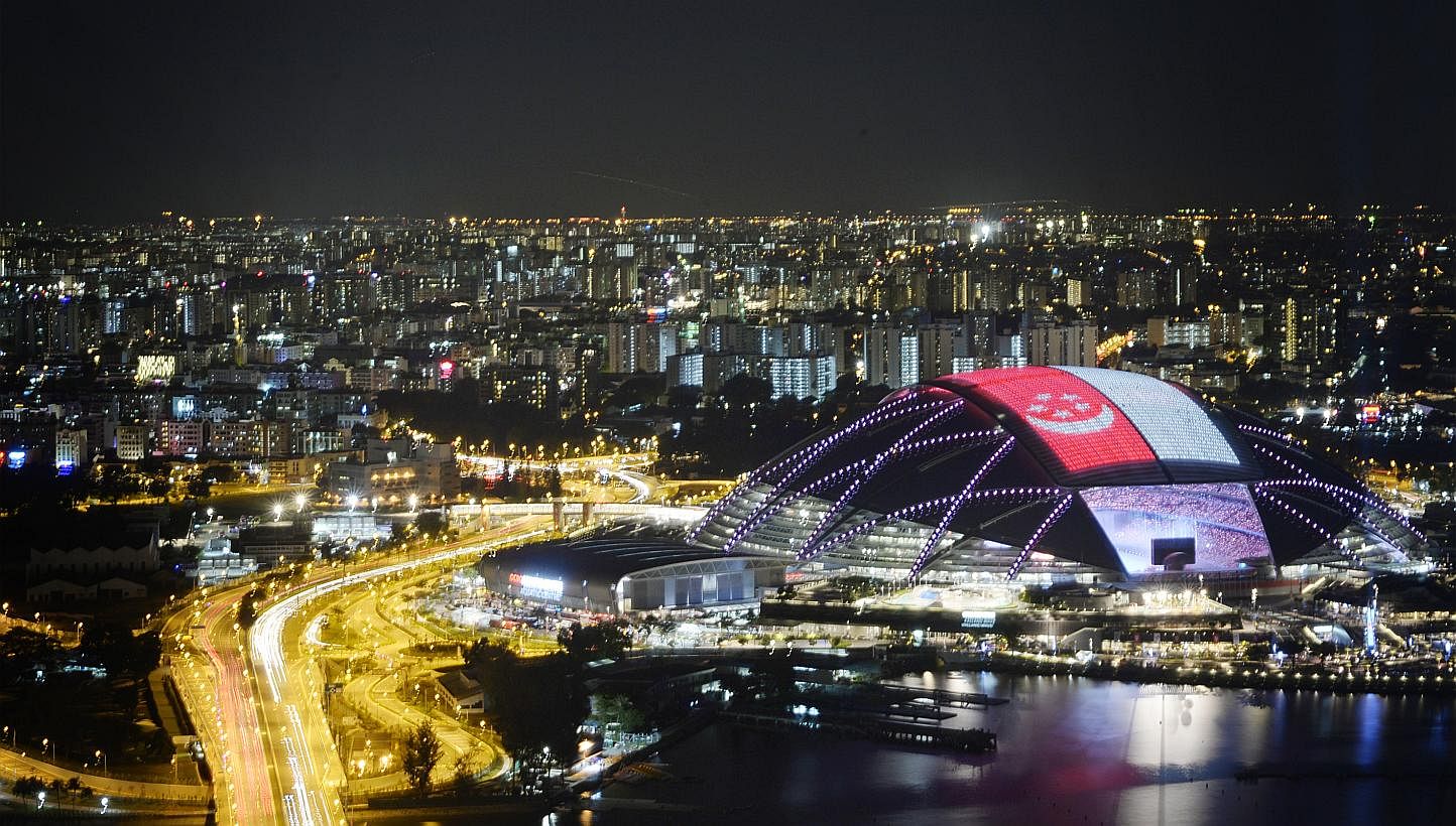 A giant Singapore flag on the roof of the Sports Hub during the 28th SEA Games Opening Ceremony held at the National Stadium on June 5, 2015. -- ST PHOTO: MARK CHEONG&nbsp;