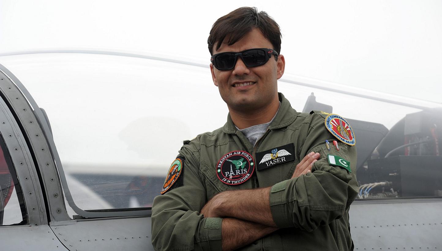 Pakistan Air Force Squadron Leader Yaser Mudasser poses in front Pakistan's JF 17 Thunder cockpit on the tarmac of the International Paris Airshow at Le Bourget on Monday. -- PHOTO: AFP