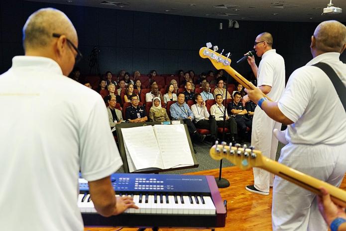 Inmates performing yesterday at the Yellow Ribbon Song Writing Competition finale, held by the Yellow Ribbon Project and Compass. A selection of songs written by the finalists will be produced in an album by Compass and go on sale in November.