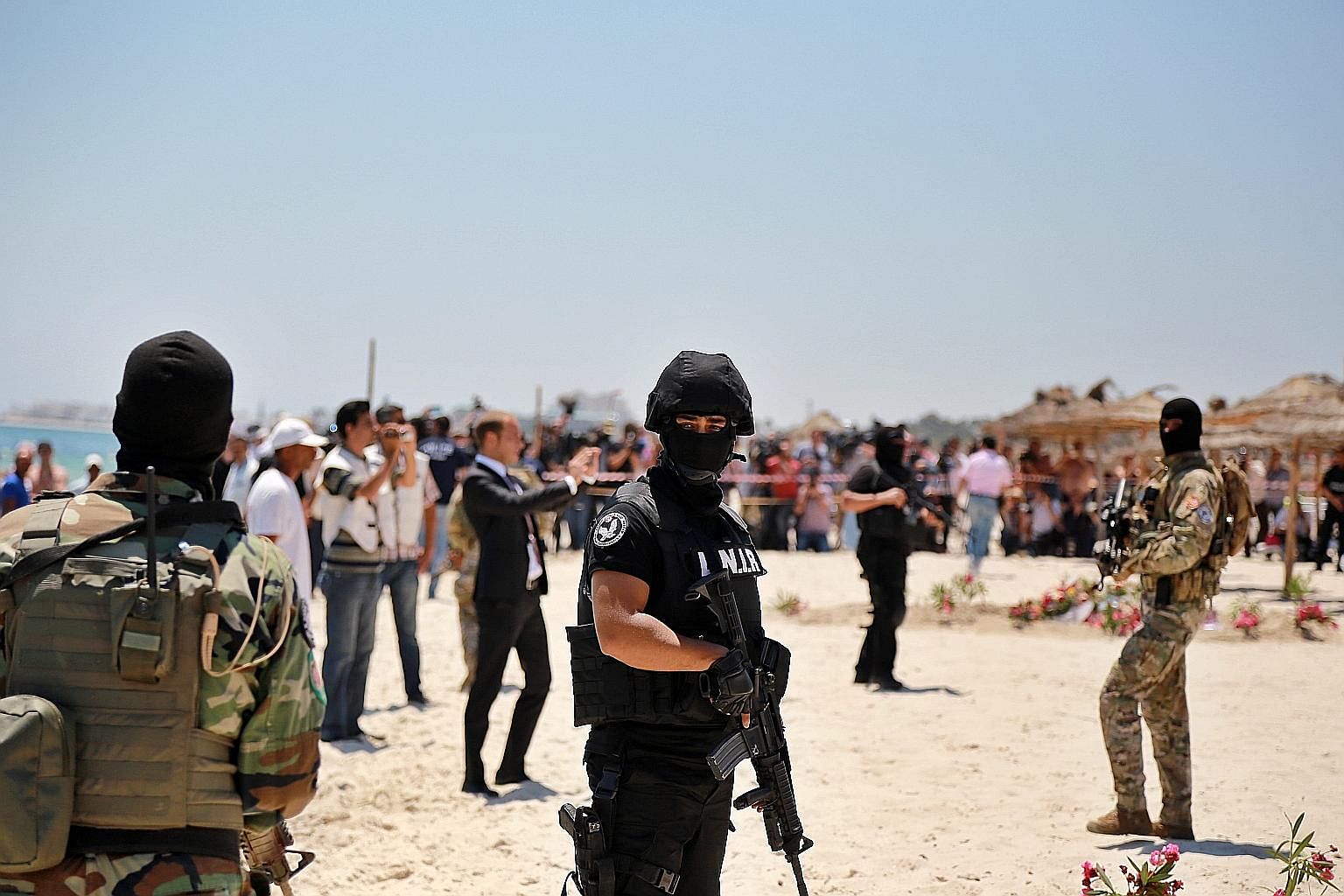 Tunisian security forces at a wreath-laying ceremony on Monday for victims of the shooting at a beach resort in Sousse, near Tunis. Addressing the root causes of extremism might help persuade those susceptible to radicalisation that they have a stake