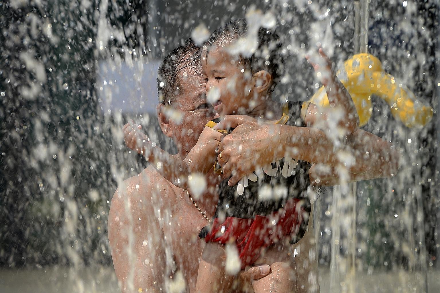 Mr Bobby Lim and his 11-month-old grandson Javen at the Sports Hub water park yesterday.