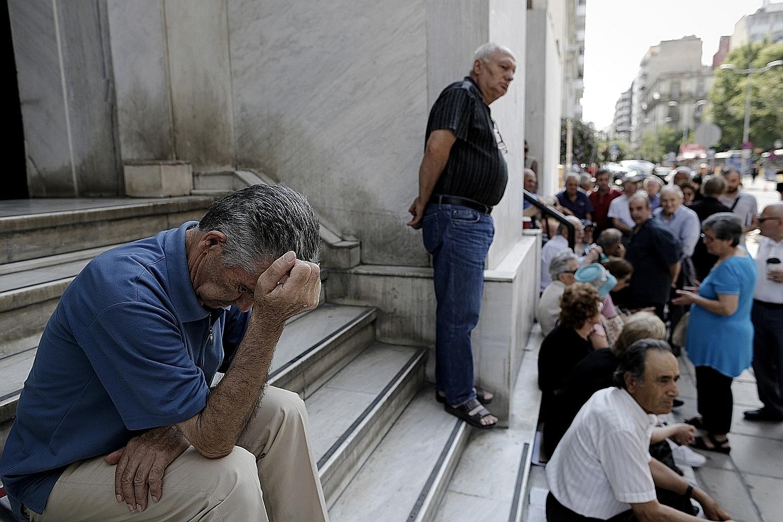 Greek pensioners waiting outside a branch of the National Bank of Greece earlier this week, in the hope that it might open. Greece has closed banks and imposed capital controls in an attempt to avert the collapse of its financial system.