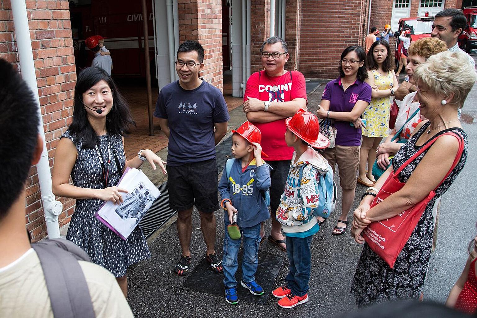 Volunteer guide Lee Ai Ling offered a glimpse of the lives lived behind some of Singapore's old monuments. Among the 18 who joined her tour were Mr David Siauw (in blue) with two of his children.