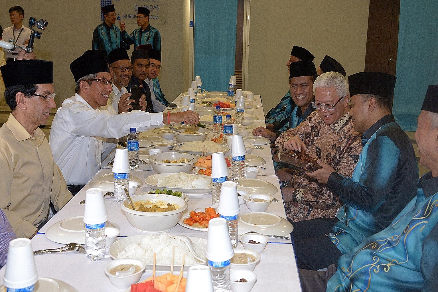 An-Nur Mosque executive chairman Abdul Rahim Mawasi (far right) offering dates to President Tony Tan Keng Yam yesterday during iftar, the breaking of fast, at the mosque in Woodlands. Also present at the event were the mosque's first vice-chairman Ka