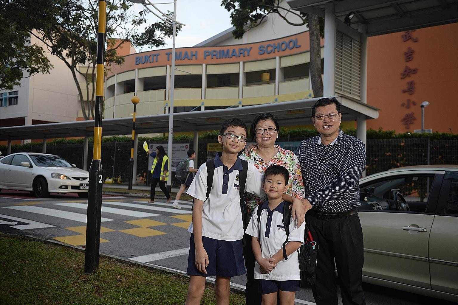 Madam Chua Huay Wen, 39, her husband Kenneth Seah, 43, and their children Jonathan (left), 11, and Matthew, eight, outside Bukit Timah Primary School, which sits among private estates and "brand-name" schools such as Pei Hwa Presbyterian and Methodis
