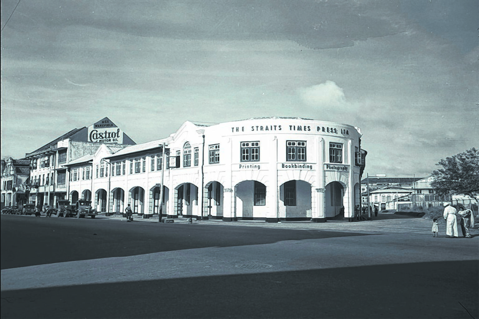 A linotype machine (top) weighing three-quarters of a tonne being lowered from the second floor of the Straits Times office in Cecil Street before it is moved to the new building in River Valley. (Bottom) The Straits Times building in Anson Road in a