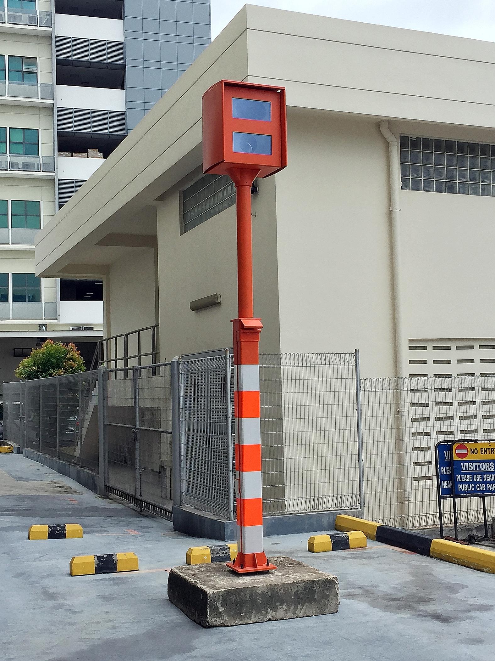 The Traffic Police will paint digital red-light cameras orange and paste reflective stickers on them to boost visibility.
