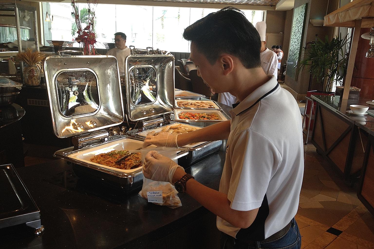 Mr Jasper Tan from ALS Life Sciences taking samples from Fullerton Hotel for testing. This is part of an initiative by The Food Bank Singapore to get hotels and restaurants to donate excess food.