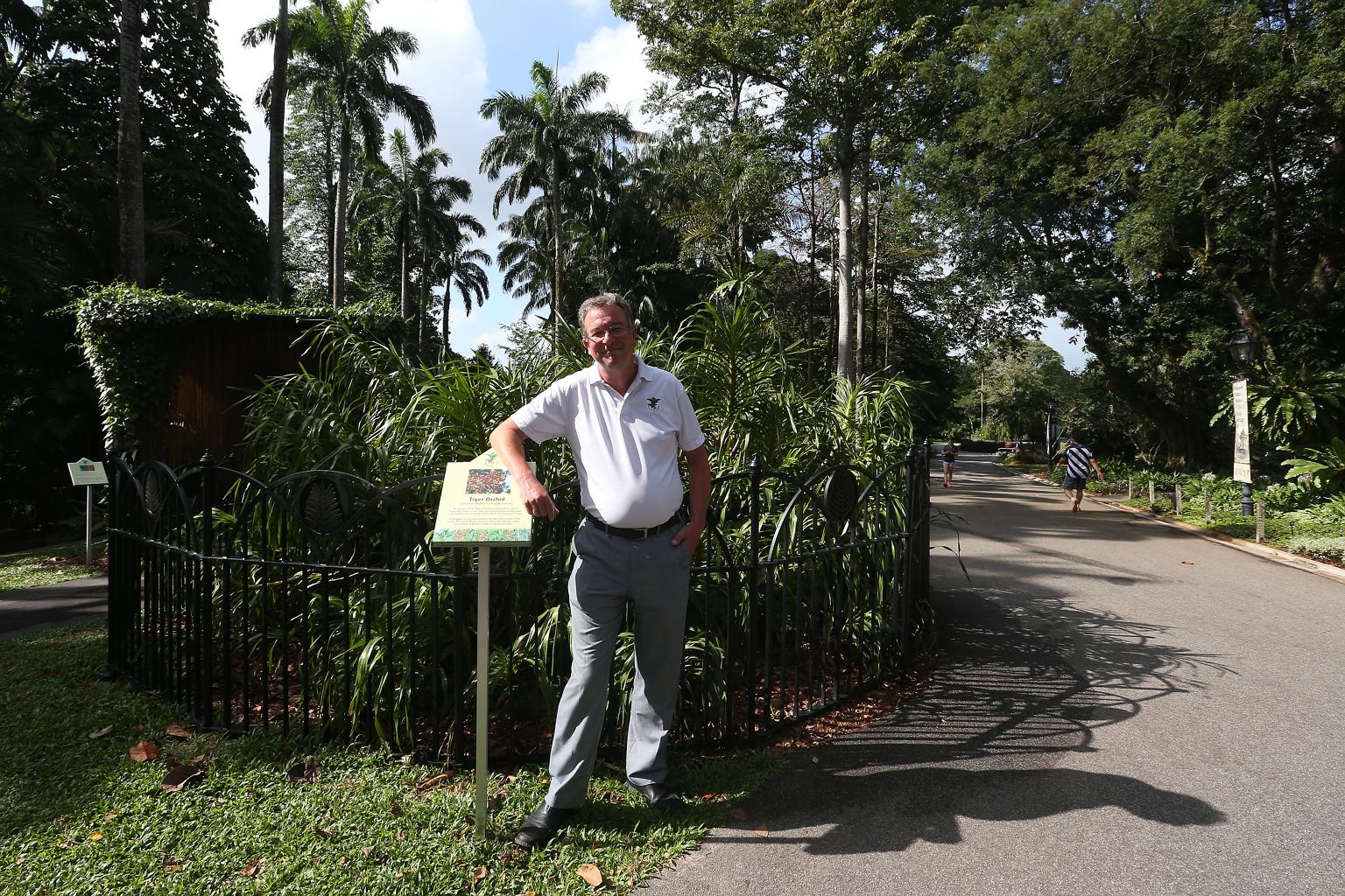 Dr Nigel Taylor with unbloomed tiger orchid plants at the Botanic Gardens. His research on the Gardens led him to piece together a series of photos documenting the marked transformation of one of its tiger orchids over the course of 154 years.