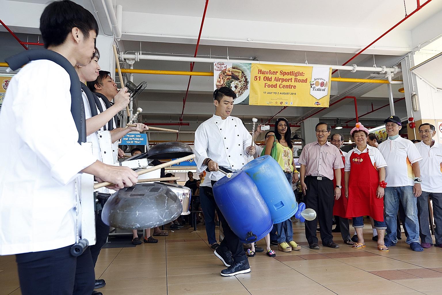 Moutbatten MP Lim Biow Chuan (fourth from right), along with representatives from the Singapore Tourism Board and the Old Airport Road (51) Merchants Association, watching musicians put on a show using pots, plastic barrels and other cooking ware at