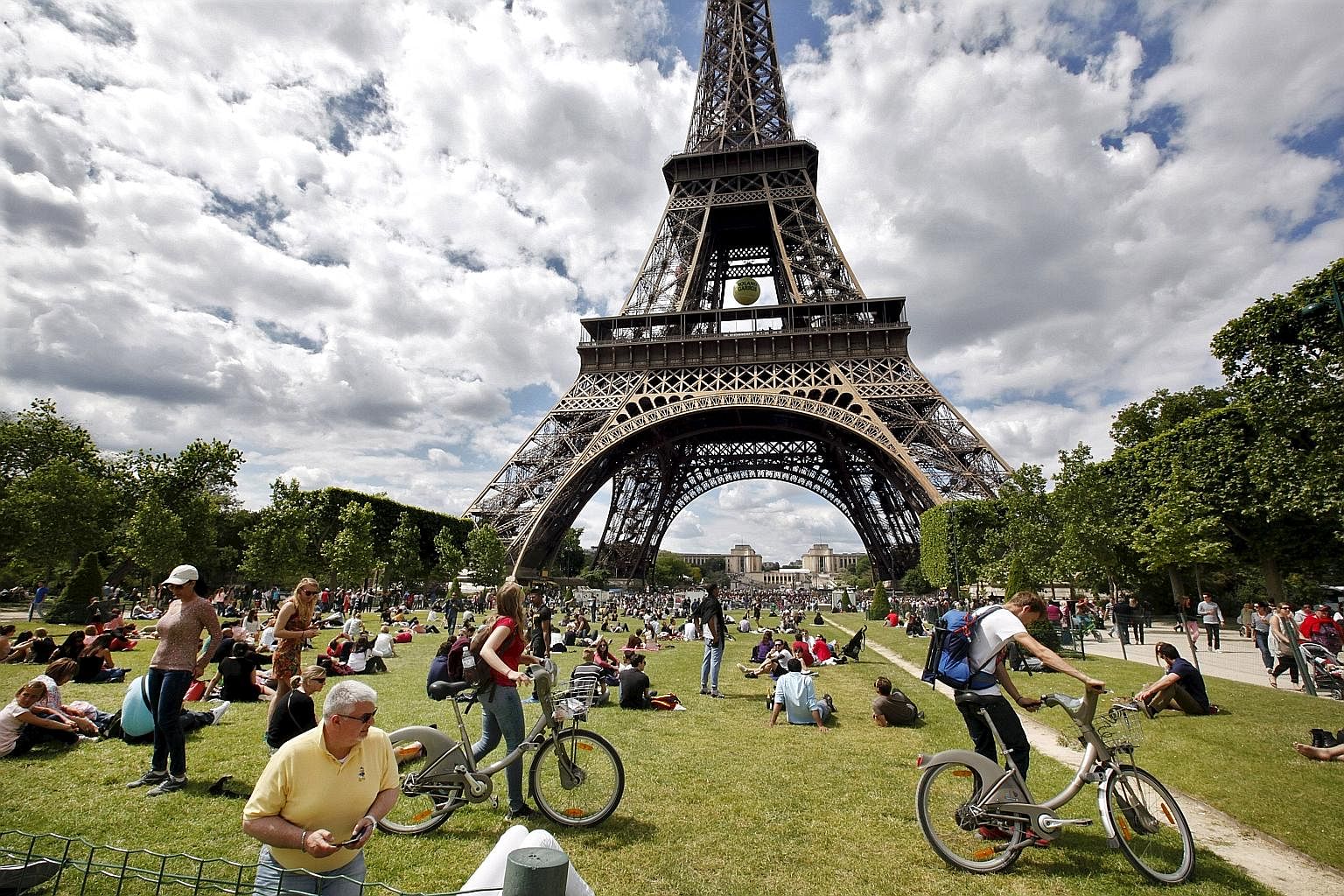 The Eiffel Tower (above) in Paris draws seven million visitors each year. Tourists, while contributing to the world's local economies, are overcrowding them as well. So much so that there has been a backlash against tourism in many cities, including 