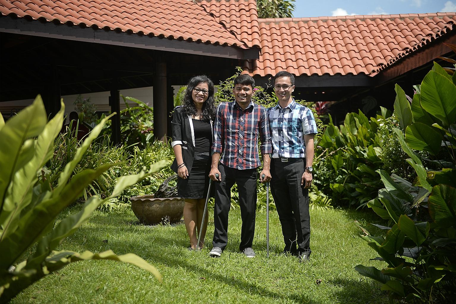 Mr Chhap Longly (centre), 25, with Hagar client care operations manager Sam Sreyna (far left), 25, and Hagar counselling project manager Seng Mang, 29, in Singapore yesterday. In Cambodia, Hagar helps 50 new "clients" like Mr Chhap each year.