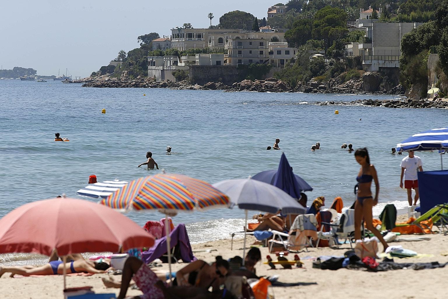 Locals on a beach near the Saudi king's villa. The closure of the beach in front of the villa has enraged residents.
