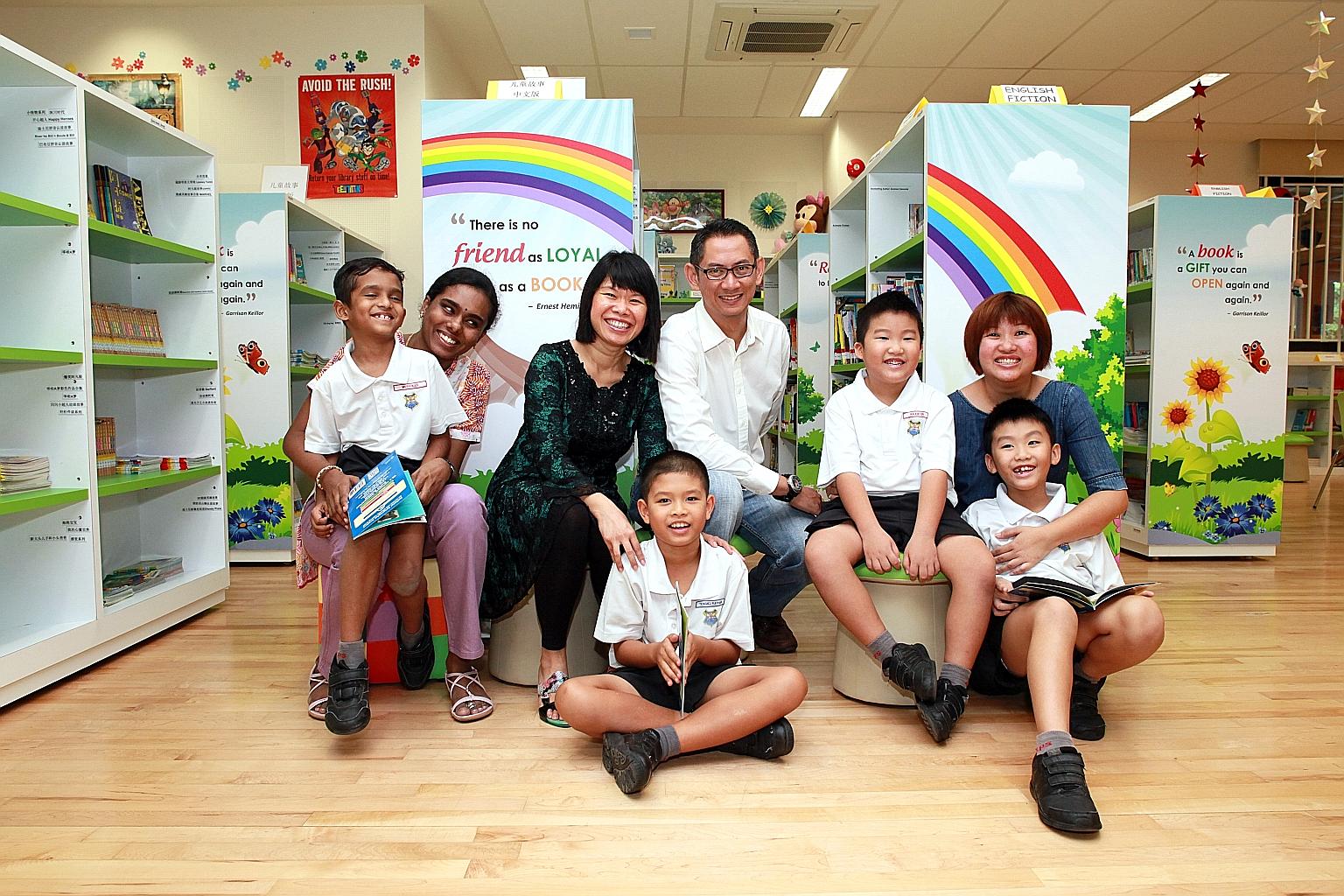 Pupils and parents from Alexandra Primary School - (from left) Primary 1 pupil Muthukasi Vairaran Muthiah, seven, his mum Kavitha Palaniappan; Madam Cassandra Nadira Lee with her son Tengku Rayhan Tengku Razman (seated), eight, and husband Tengku Raz