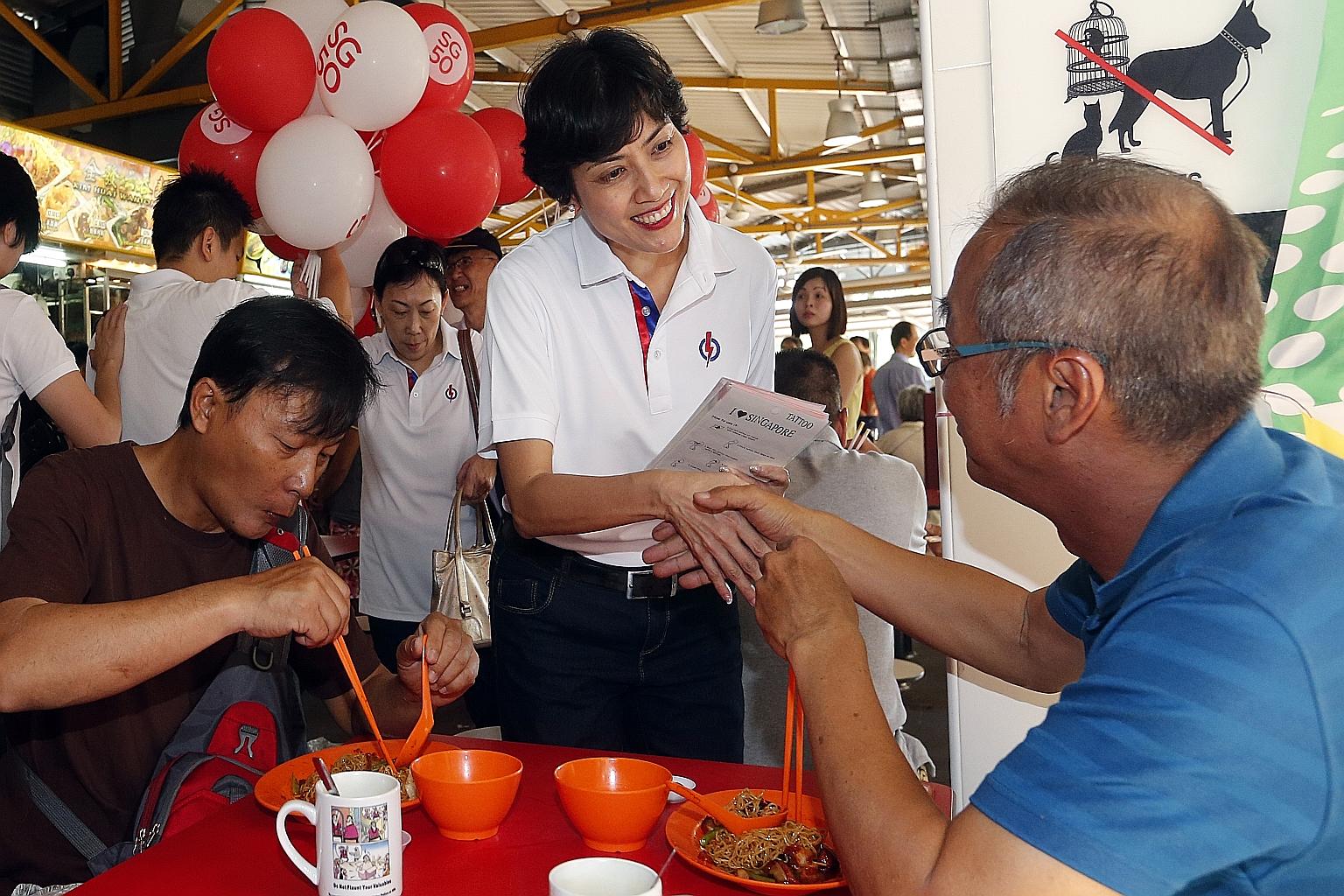 Ms Joan Pereira greeting a diner at Bukit Merah View Market and Food Centre yesterday morning during a walkabout when she was introduced as a new face in Tanjong Pagar GRC. She is no stranger to the area, having worked at Queenstown Community Centre