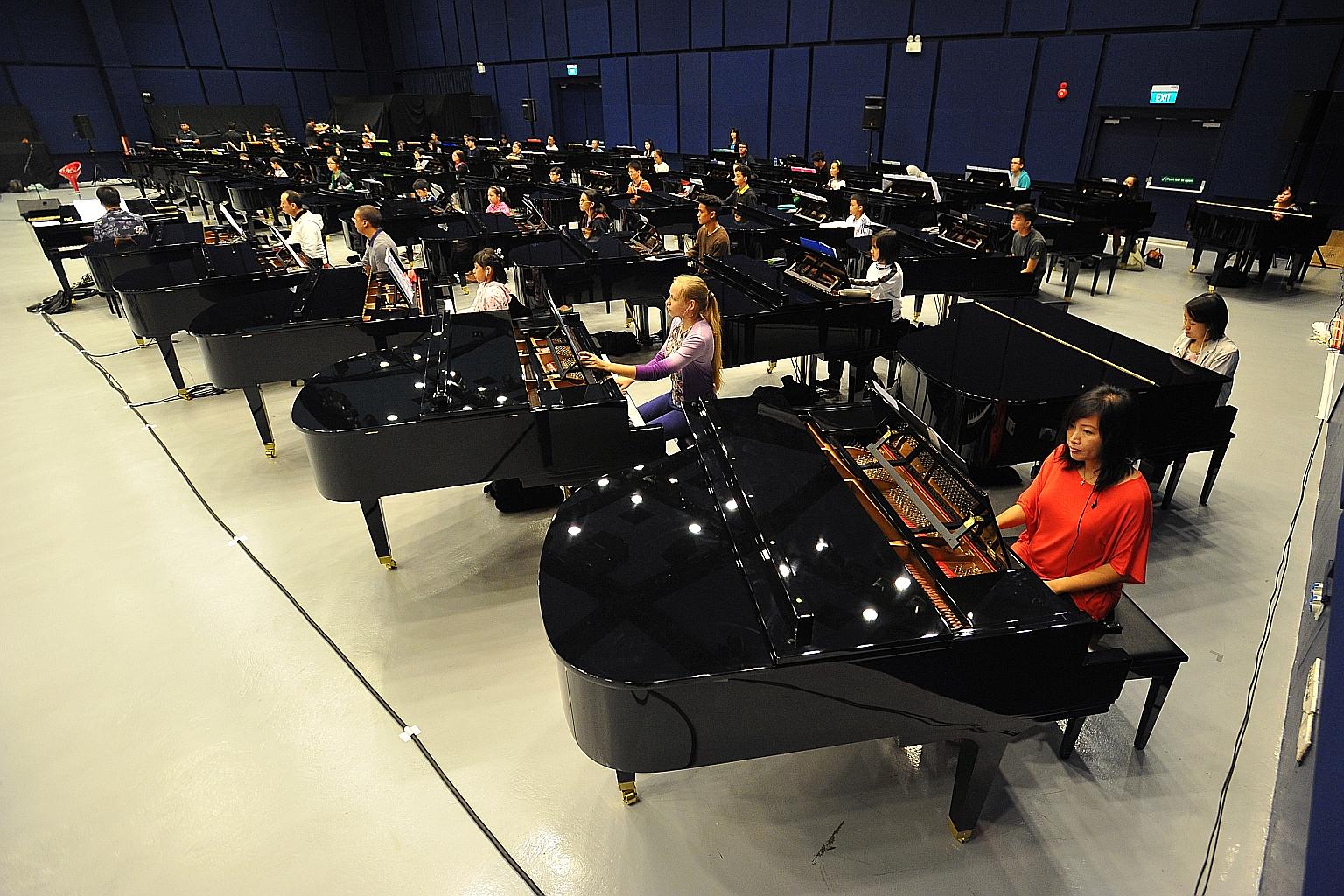Pianists at a rehearsal last month for the Sing50 concert. Insurance group Zurich has pledged to donate $5 for every person who attends the show. Mr Jonathan Rake, chief executive of Zurich's general insurance business in Singapore, encouraged those 