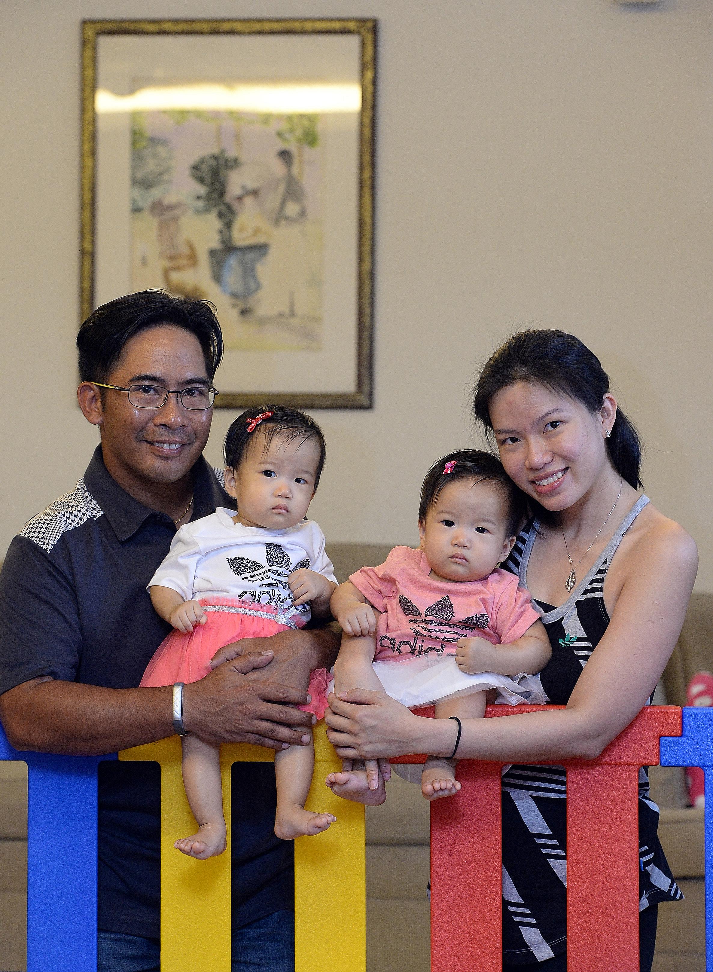 Mrs Regine Sahetapy and her husband Carl with their twin daughters Gabrielle (left) and Noelle, who were conceived naturally and were born in September last year.