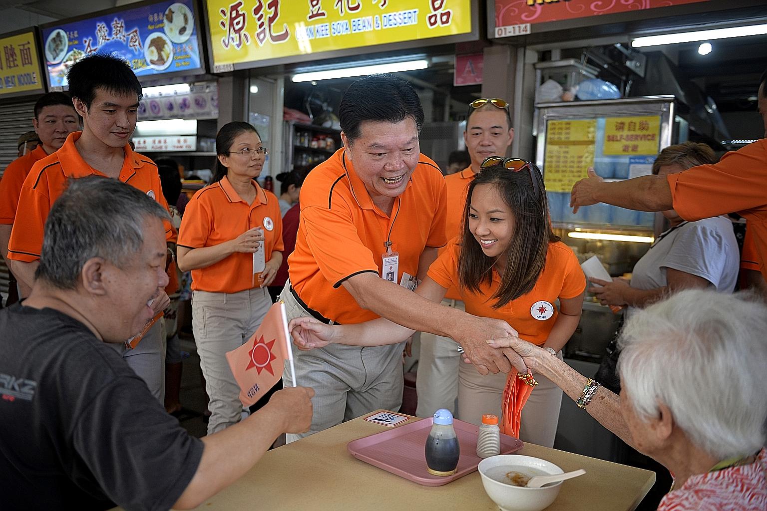Ms Nicole Seah (above) at her home in 2011. Many constituents were won over by her eloquence and charisma.National Solidarity Party president Sebastian Teo (right, centre) and party member Kevryn Lim greeting MacPherson residents at the Circuit Road