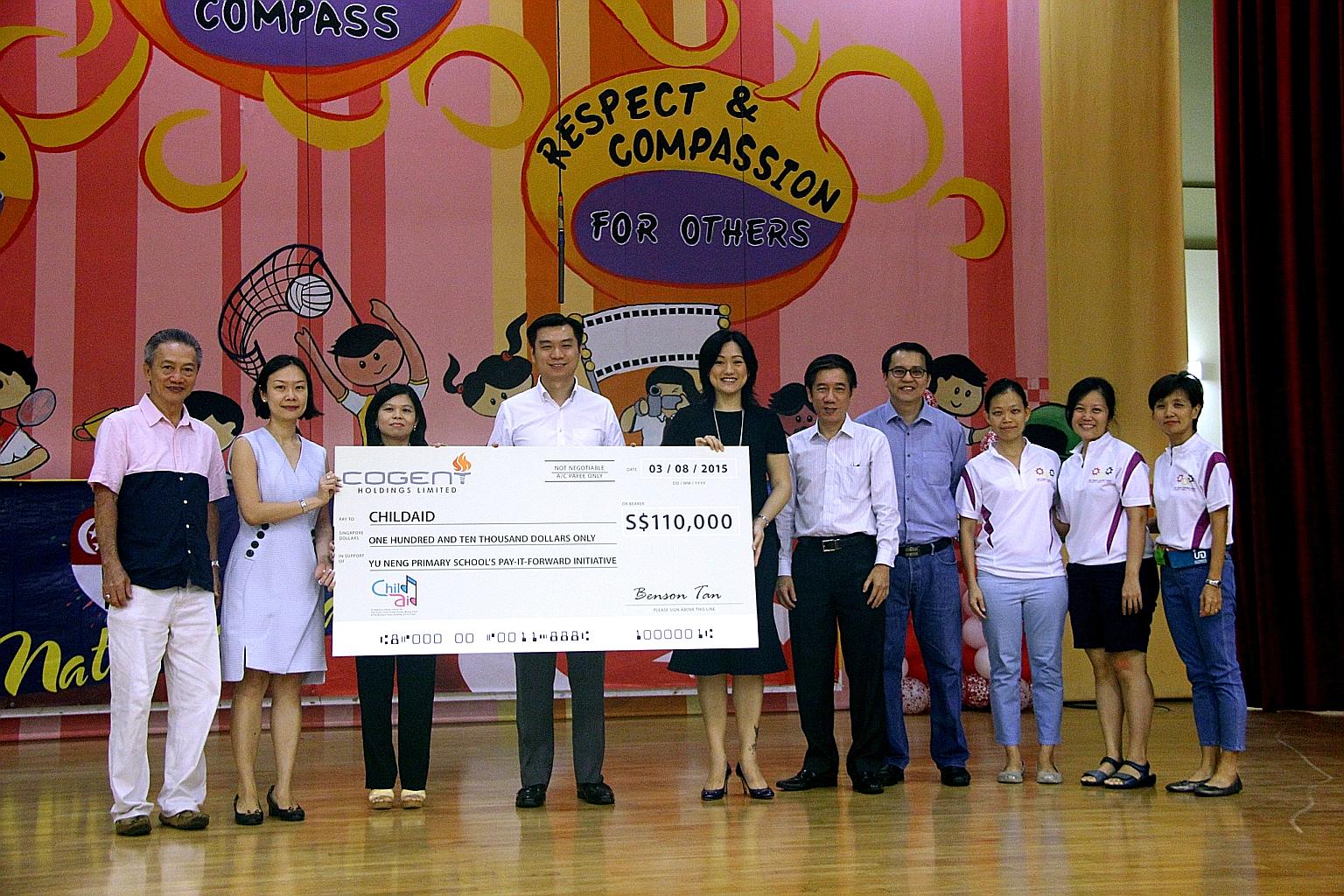 Coming together for children are: (from left) Mr Ng Beng Chok (chairman of Yu Neng Primary School's advisory committee), Mrs Clara Lim-Tan (the school's principal), Ms Tan Bee Heong (general manager of The Straits Times School Pocket Money Fund), Mr