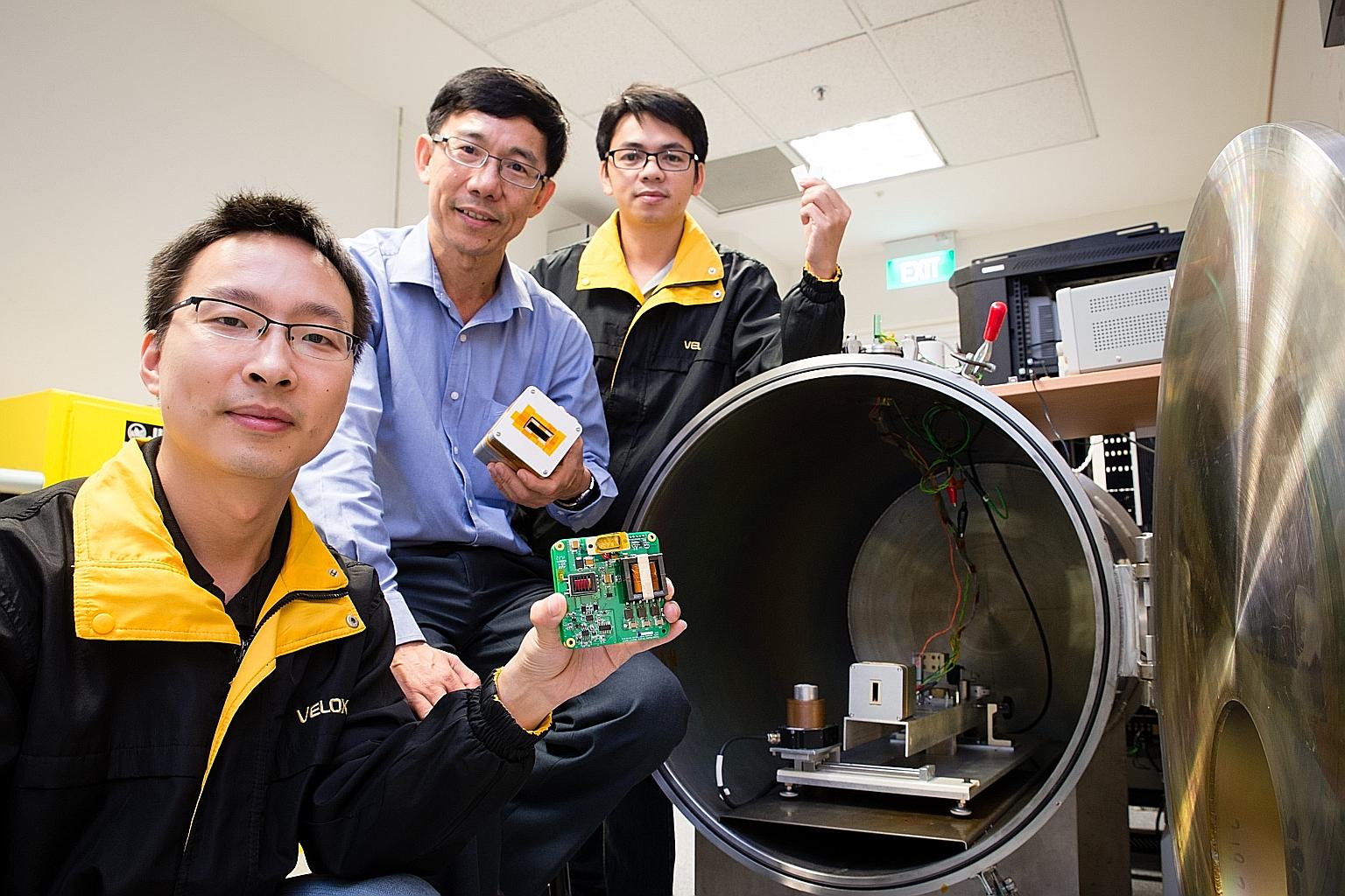 NTU's Associate Professor Low Kay Soon (centre) with his researchers on the project. The university worked with Japan's Kyushu Institute of Technology on a nanosatellite which will be delivered to the ISS for launch next year.