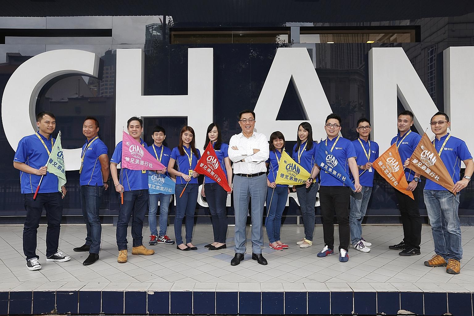 Chan Brothers group managing director Anthony Chan (centre, in white shirt) and his tour consultants. Among them is Mr Vincent Tham (second from left), who was one of the firm's first tour managers.