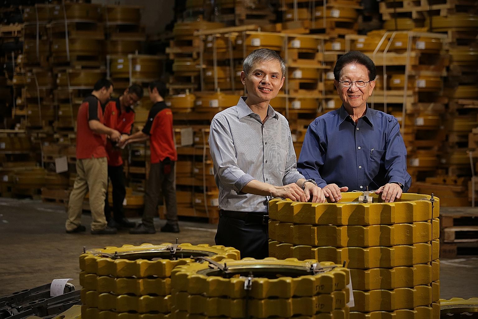 Kian Ann Engineering group managing director Loy Soo Chew (left), 48, and founder Low Han Cheong, 80, at their warehouse complex in Changi. Even though the company was bought by South Africa's Invicta Holdings in 2013, the latter wants local top mana