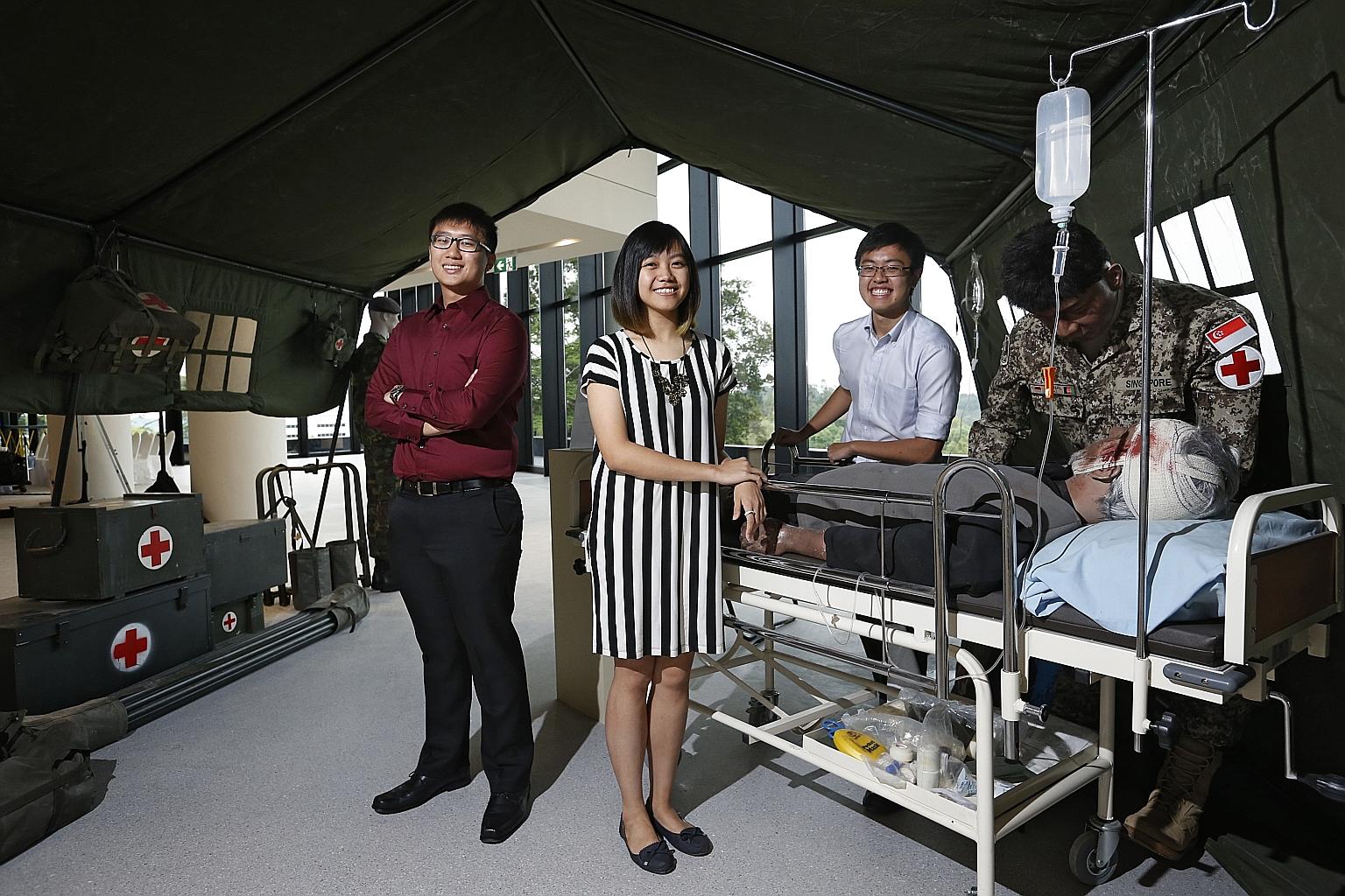 Second-year students (from left) Berwyn Tan, 19, Candice Loh, 19, and Shawn Tan, 20, at the opening of the Humanity in Medicine exhibition at NTU Lee Kong Chian School of Medicine's Experimental Medicine Building yesterday.
