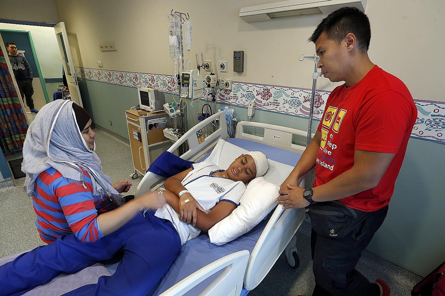 Tanjong Katong Primary School pupil Emyr Uzayr being treated in hospital after he was flown back from Sabah, following the earthquake in June.