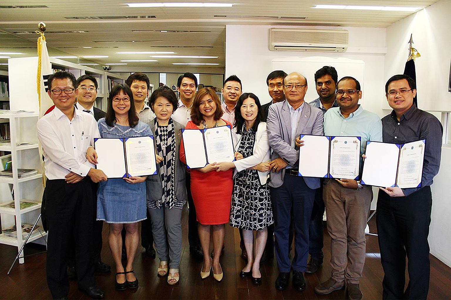Korean Association chairman Noh Chong Hyun (front row, third from right) and association staff with some of the rescuers who helped accident victim Kim Sung Mo.