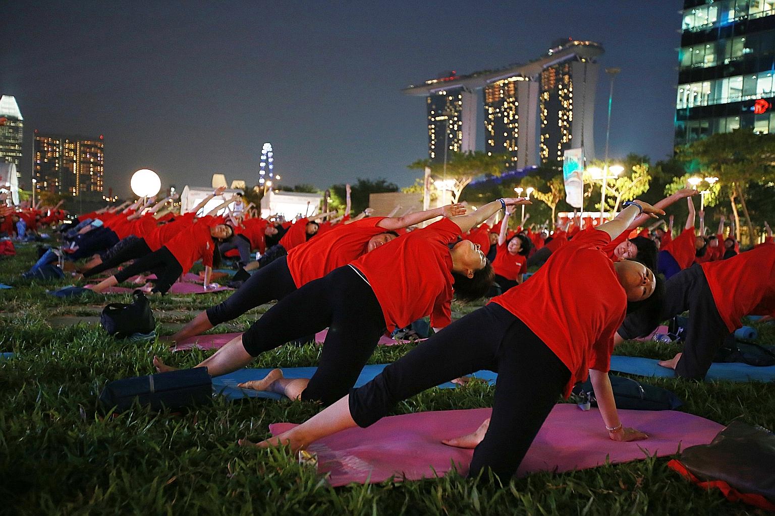 Participants at a mass yoga event at The Lawn @ Marina Bay - an open area above Marina Bay Link Mall. Thursday's fitness event drew about 500 people. It was organised by My Paper, the bilingual newspaper published by Singapore Press Holdings. Places