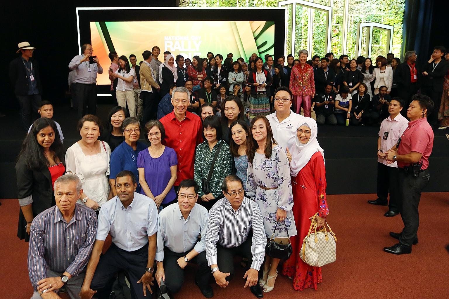 Prime Minister Lee Hsien Loong having a photo taken with a group of people who attended his SG50 National Day Rally at ITE Central last night.