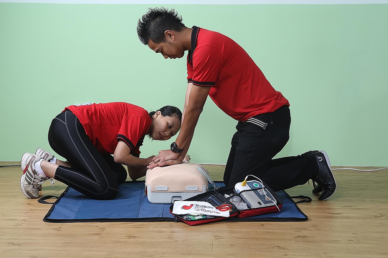 Participants in a training class practising cardiopulmonary resuscitation, to be used alongside the automated external defibrillators.