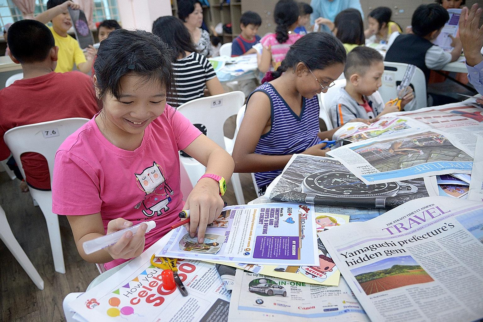 Children at Ang Mo Kio Family Service Centre - Basic enjoying their financial literacy lesson which comes in the form of scrapbooking activities based on material from The Straits Times.