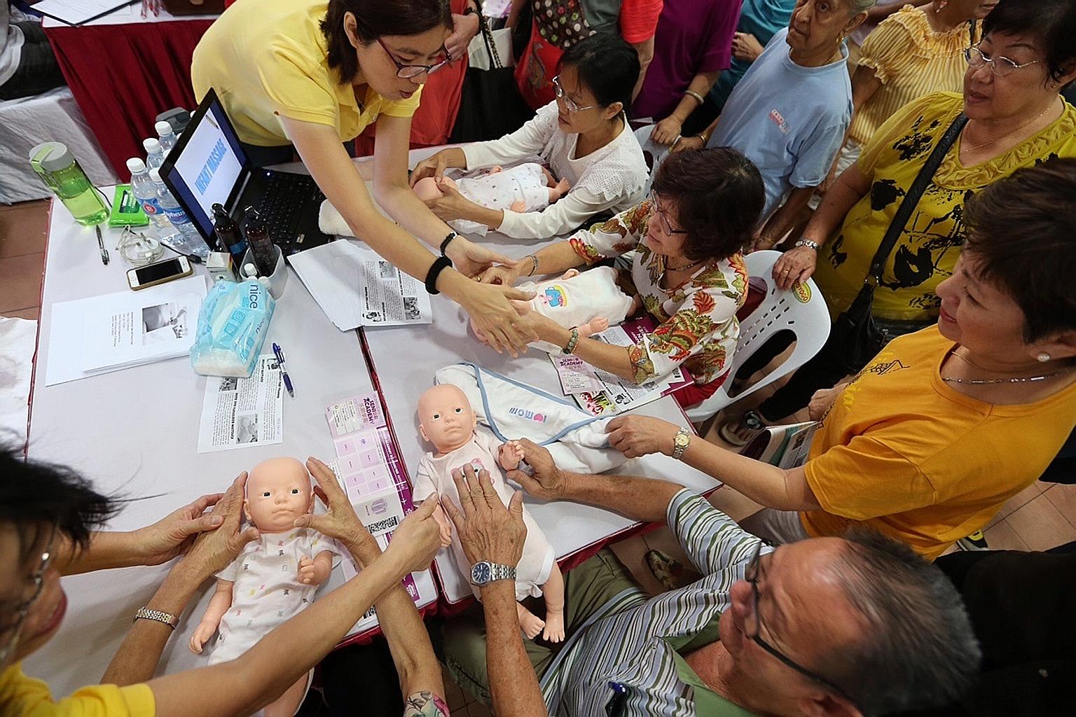 Instructors from Penny Chew Massage and Healthcare teaching seniors basic health massage for babies. Launched in April, the Senior Academy Golden Work Series has seen 560 residents signing up for courses.