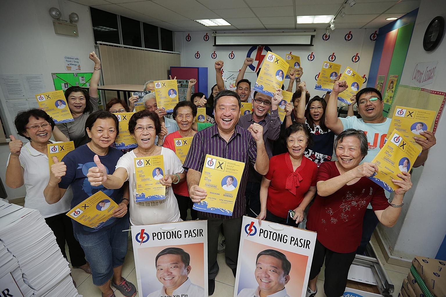 Mr Sitoh Yih Pin (centre) and Potong Pasir residents with copies of the MP's campaign manifesto which outlines his track record as well as future plans for the ward. He won the constituency for the PAP by 114 votes in the 2011 General Election.