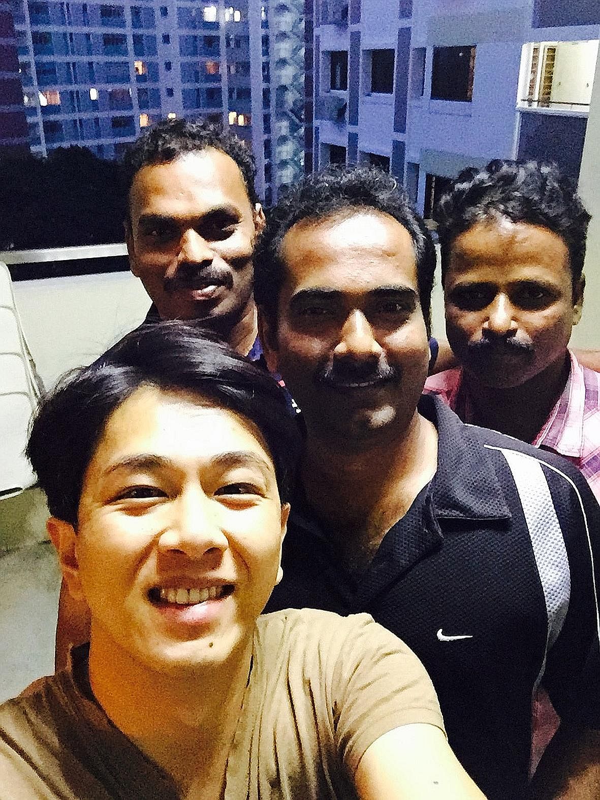Mr Sugie Phua took a photo with the three men who returned his wallet.