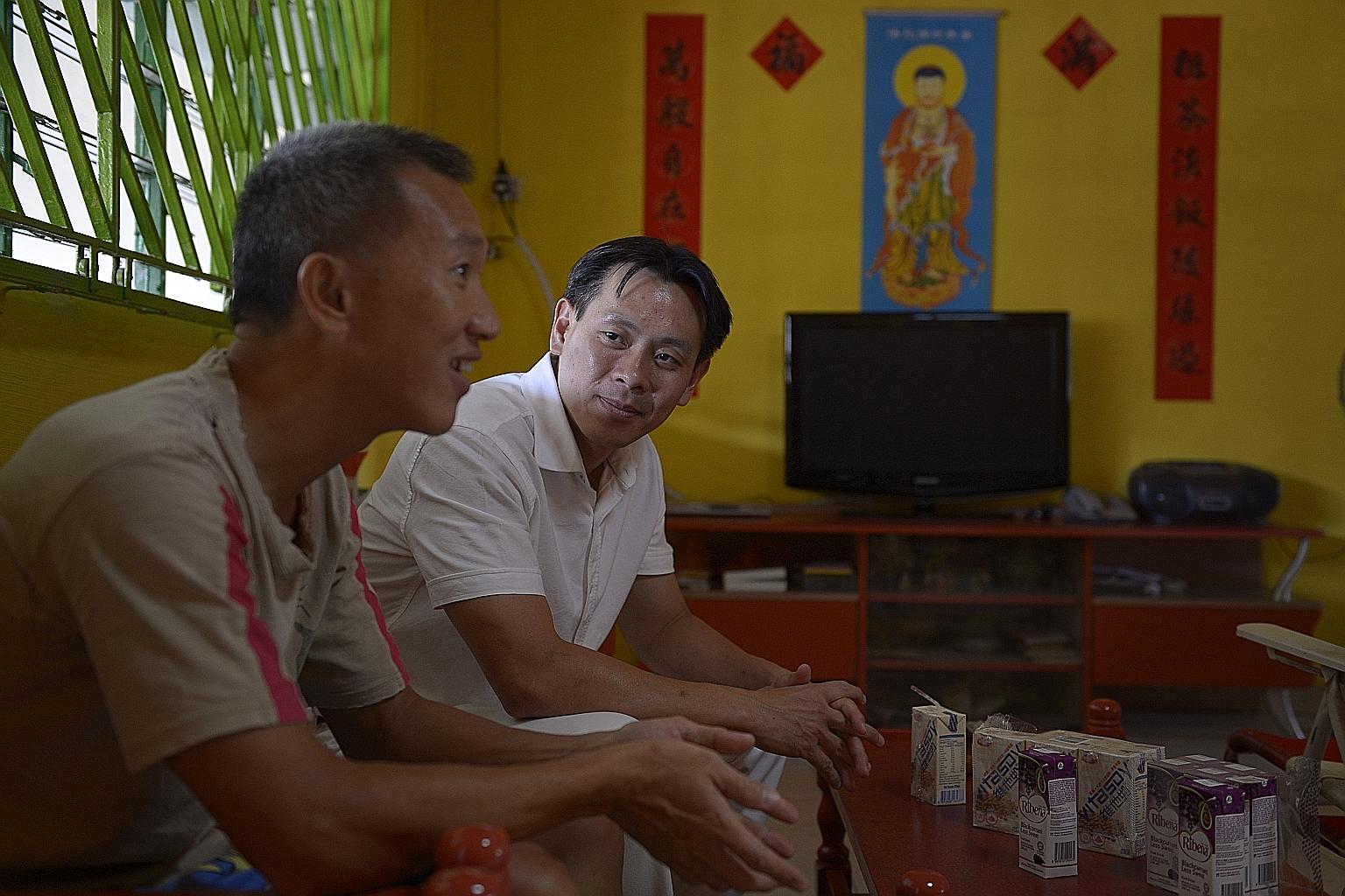 Mr Ng chatting with a resident, Mr Aw Teo Peng, 44, at his home in Yishun Street 21.