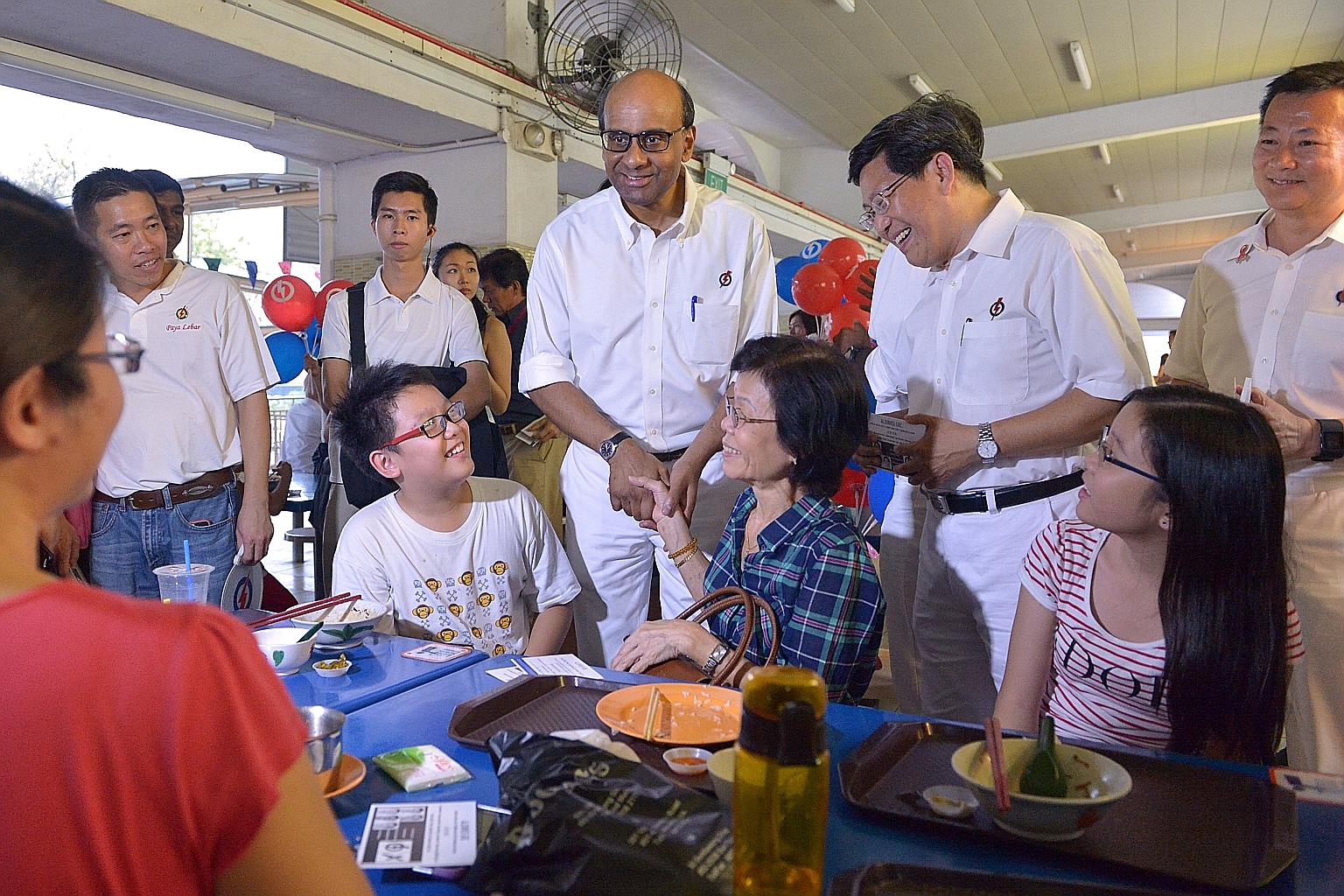 DPM Tharman Shanmugaratnam and PAP Aljunied GRC candidate Yeo Guat Kwang at Kovan Market and Food Centre yesterday.