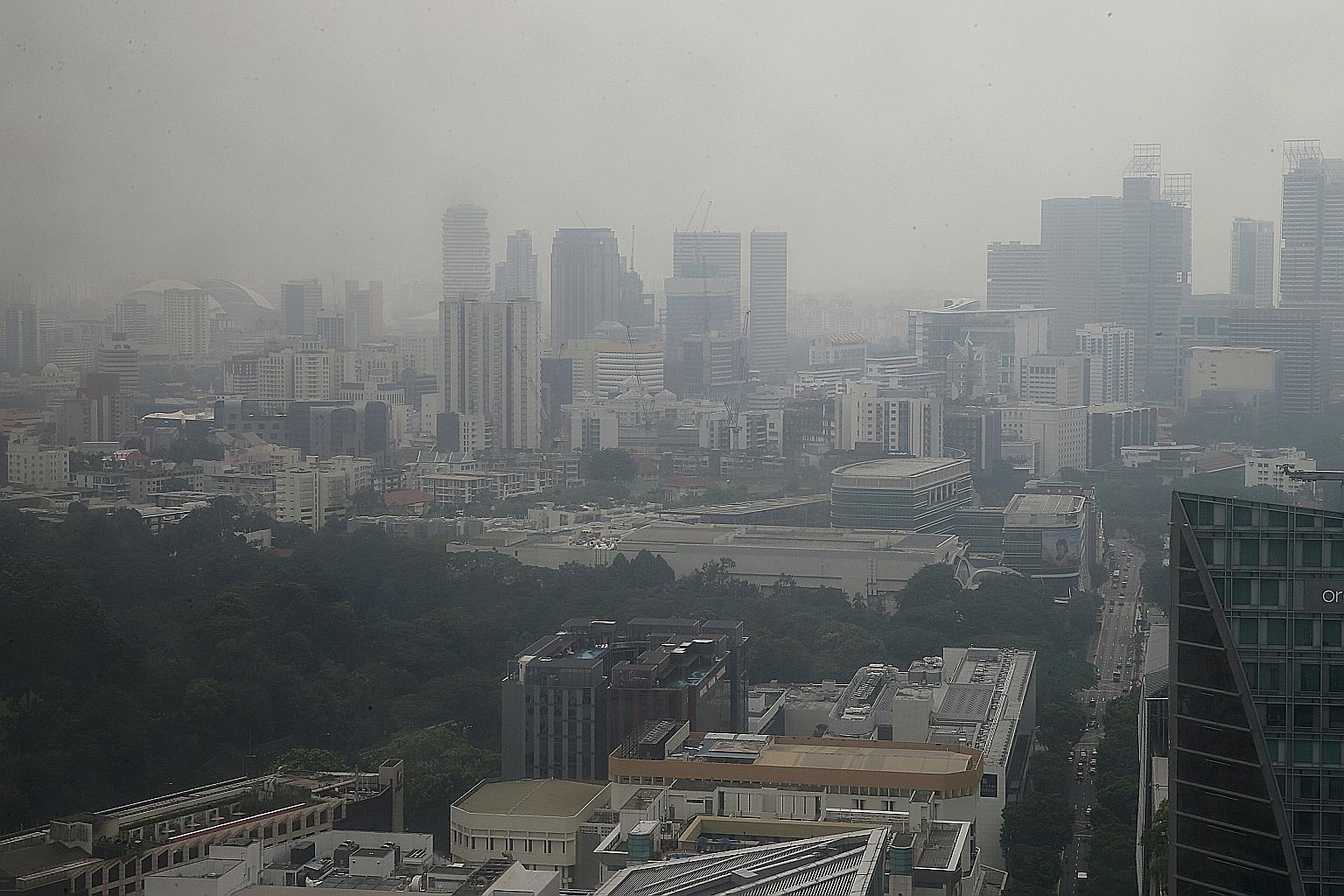 The skyline in central Singapore obscured by haze yesterday afternoon. The haze is expected to persist today, according to the National Environment Agency.