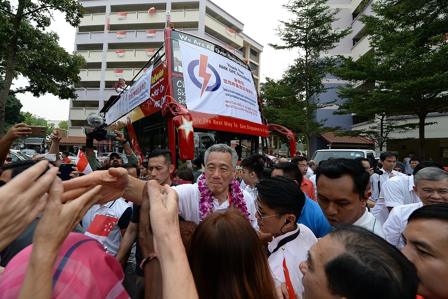 PM Lee and his Ang Mo Kio GRC teammates thanking their supporters yesterday.